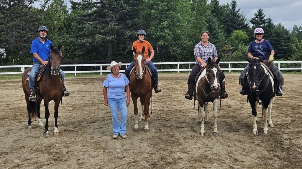 a group of horse and riders with instructor